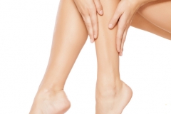 woman apply lotion on her legs